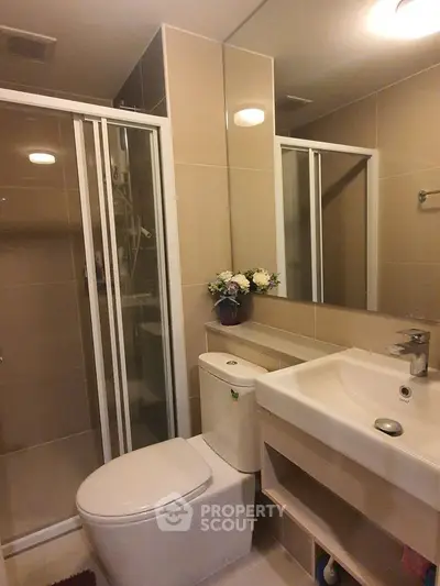 Modern bathroom with shower and elegant fixtures in a stylish apartment.