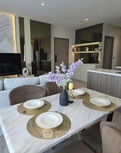 Modern open-plan living and dining area with elegant decor and stylish furniture.