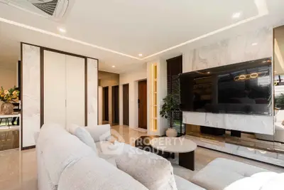 Luxurious modern living room with plush sofa and large TV