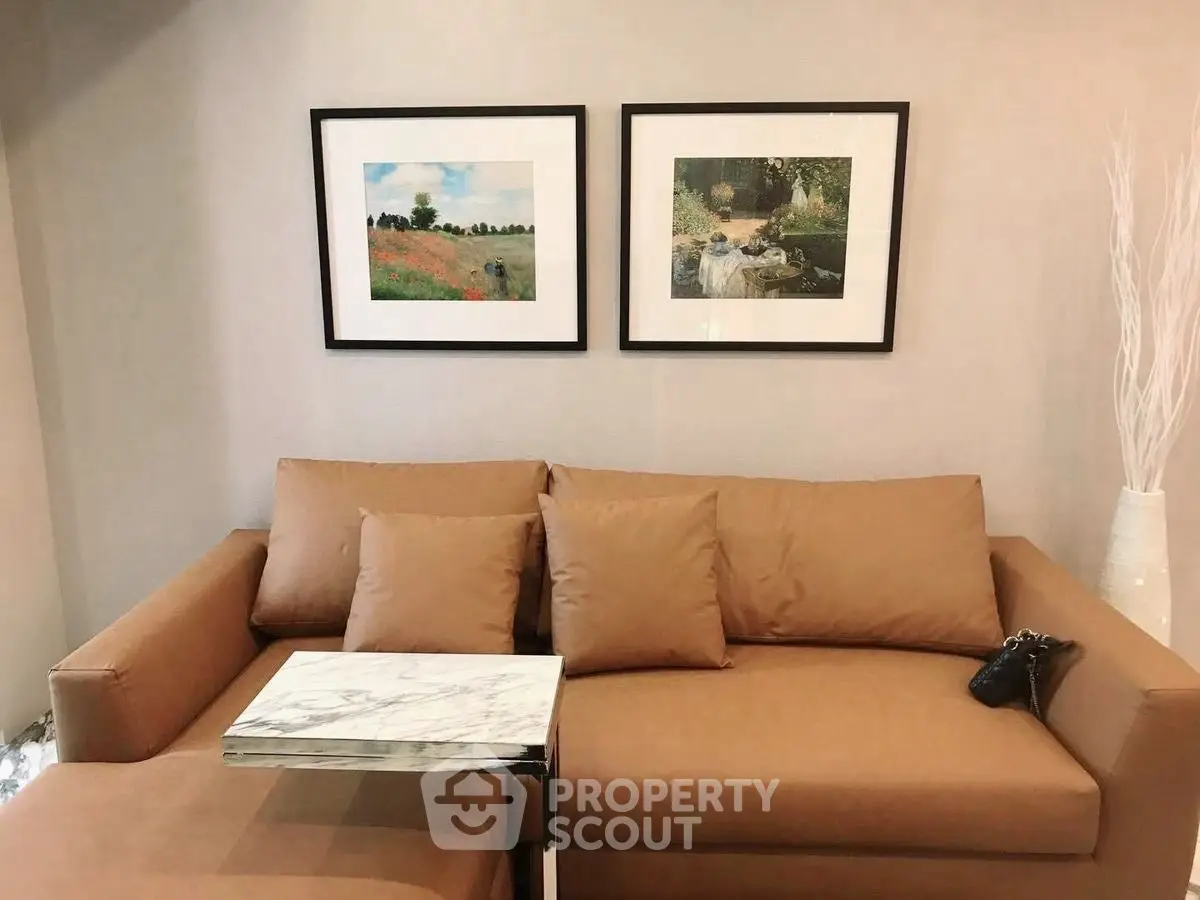 Stylish living room with modern brown sofa and elegant wall art.