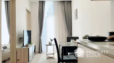 Modern living room with dining area and large window, featuring elegant curtains and sleek furniture.