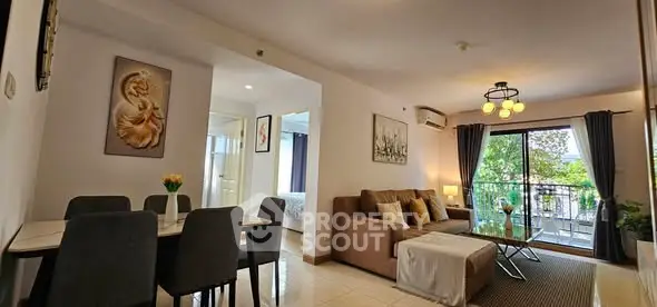 Spacious living room with elegant decor and balcony view in modern apartment.