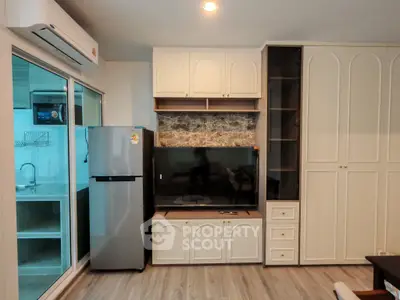 Modern living room with built-in cabinets and sleek appliances