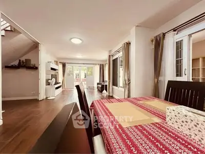 Spacious open-plan living and dining area with elegant decor and natural light.