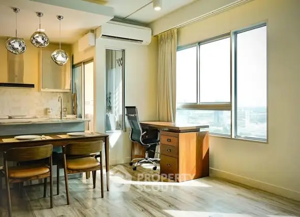 Modern apartment interior with dining area and study desk by large window.