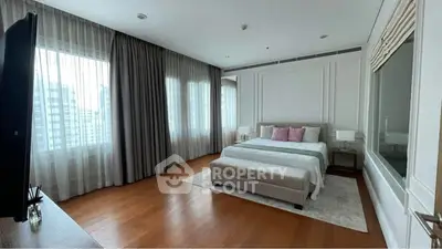 Spacious modern bedroom with large windows and elegant decor