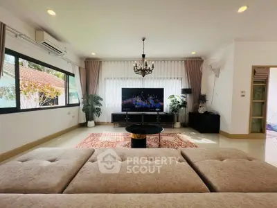 Spacious living room with elegant decor and large windows in a modern home.