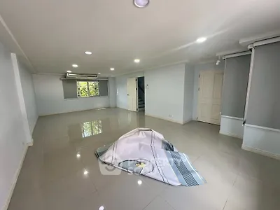 Spacious empty room with glossy tiled floor and large windows, ideal for customization.