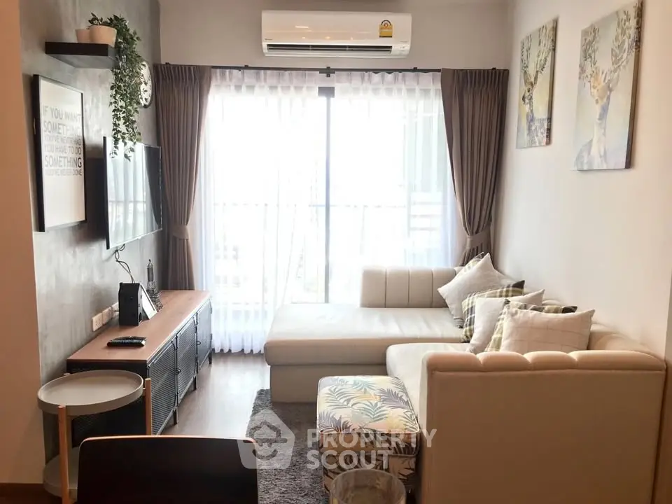 Chic and cozy living room with modern decor and ample natural light from large windows.