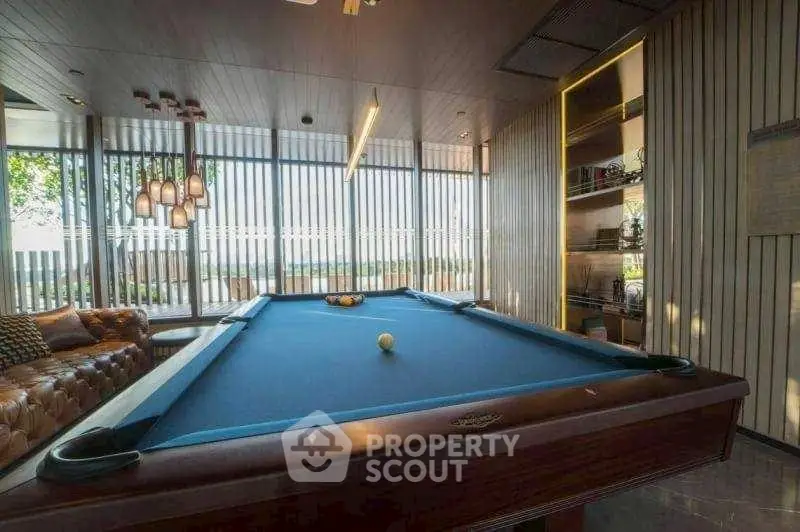 Luxurious game room with pool table and stylish decor, perfect for entertainment.