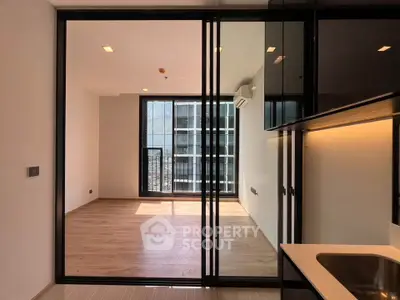 Modern apartment interior with open layout and large windows for natural light.