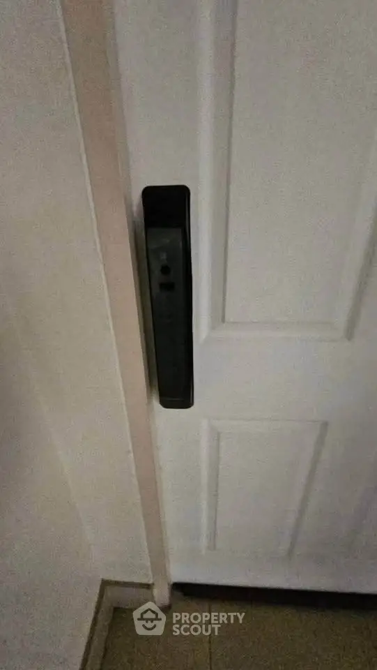 Modern interior door with sleek black handle in a contemporary home setting.