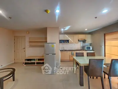Modern open-layout kitchen and dining area with sleek appliances and stylish furniture.