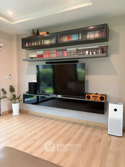 Modern living room with sleek TV setup and stylish shelving
