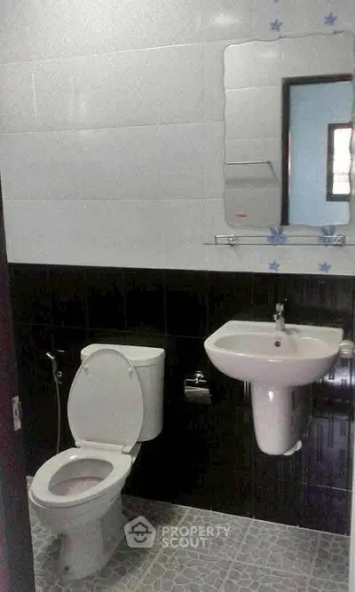 Compact bathroom with modern fixtures and tiled flooring, ideal for small spaces.