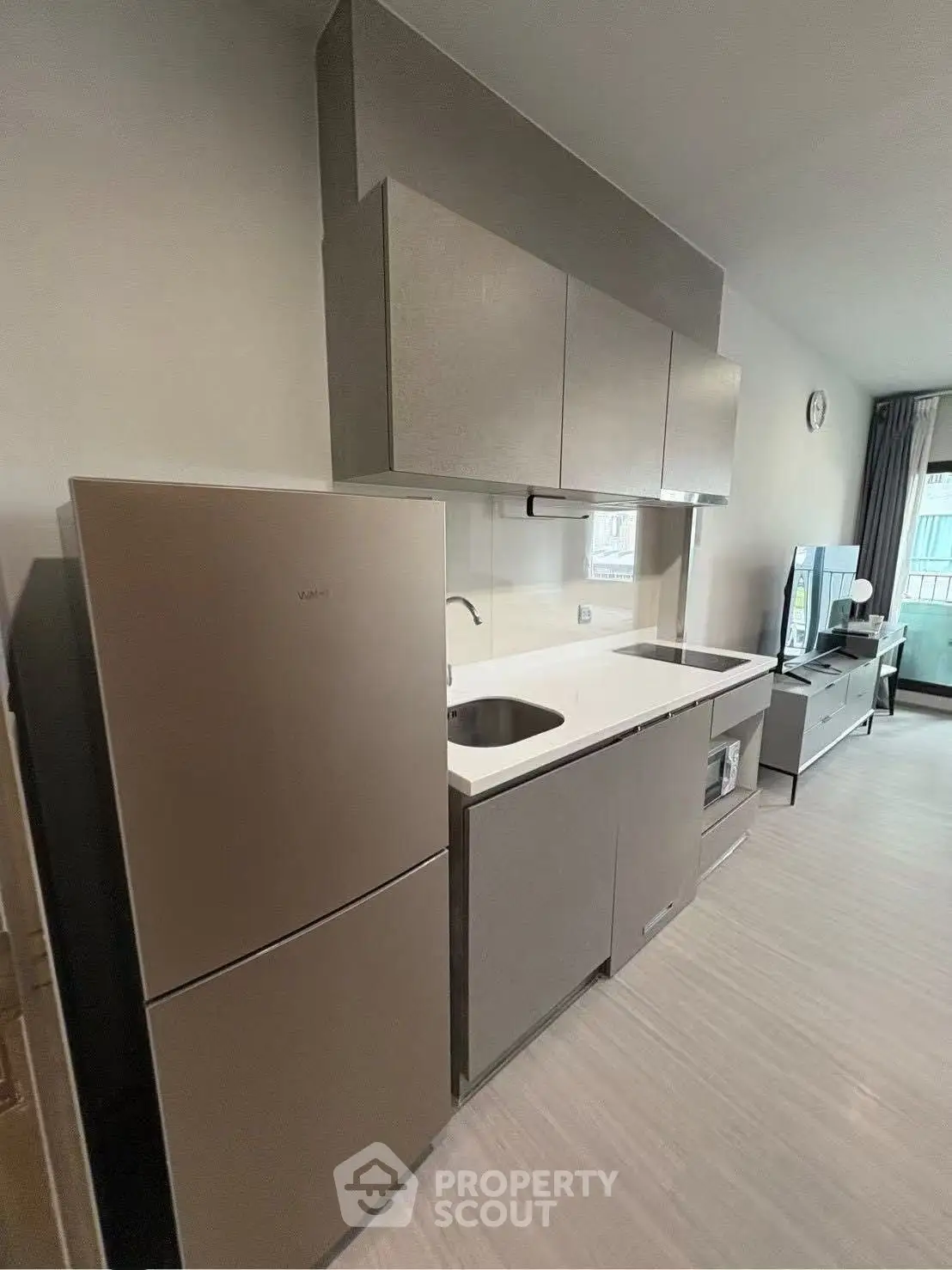 Modern kitchen with sleek cabinetry and integrated appliances in a stylish apartment.