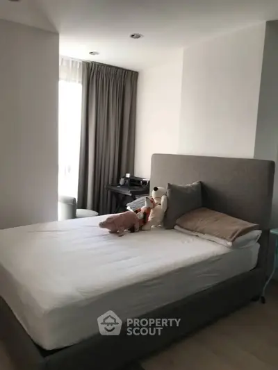Cozy bedroom with plush bed and soft lighting, perfect for relaxation.