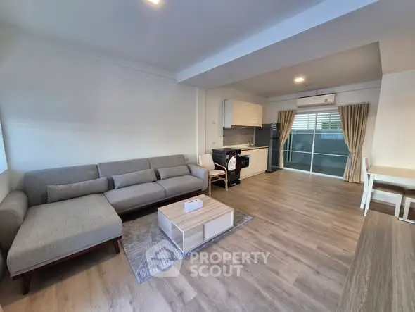 Spacious open-plan living room with modern kitchen and stylish decor