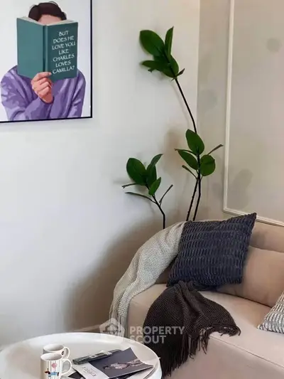 Cozy living room with modern decor, plush sofa, and stylish wall art for a welcoming ambiance.