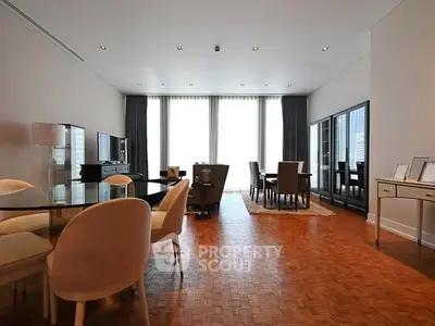 Spacious modern living and dining area with elegant parquet flooring.