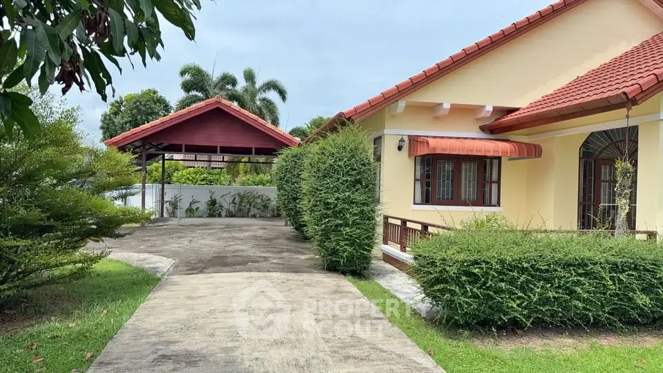 Charming suburban home with red roof and lush greenery, featuring a spacious driveway and inviting entrance.