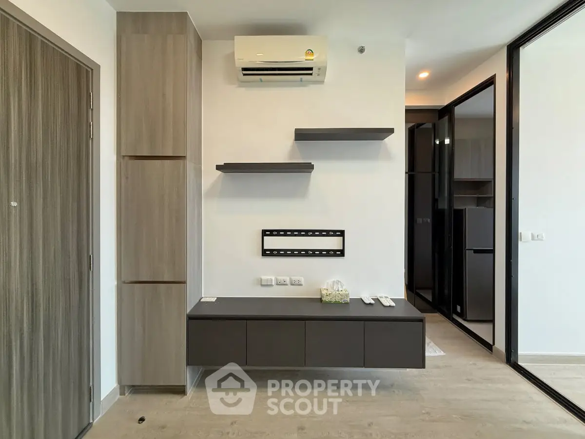 Modern minimalist living room with sleek storage and air conditioning