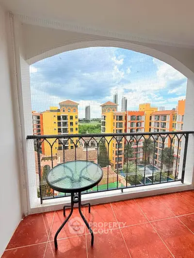 Charming balcony with stunning cityscape view in vibrant residential complex.