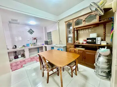 Charming kitchen with dining area, featuring wooden furniture and ample storage space.