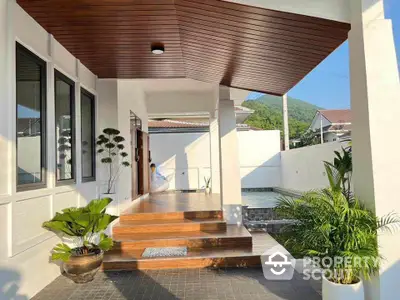 Stunning modern entrance with wooden accents and lush greenery