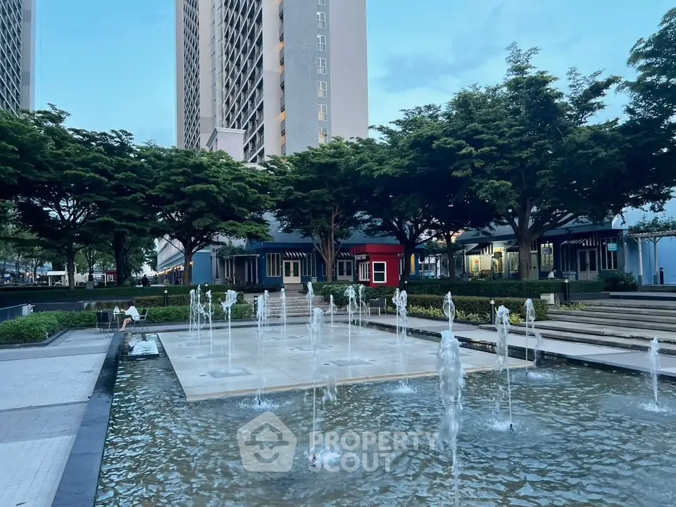 Modern urban plaza with water fountains and high-rise buildings