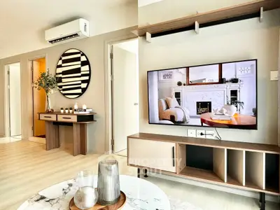 Modern living room with stylish decor and wall-mounted TV, showcasing contemporary interior design.