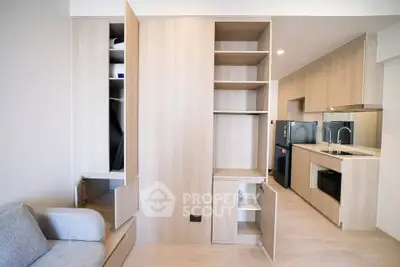Modern apartment interior with sleek kitchen and ample storage space