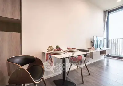Modern dining area with stylish chairs and balcony view in a contemporary apartment.