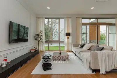 Modern living room with sleek design and large windows offering natural light.