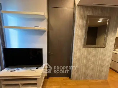Modern living room with TV and stylish decor in a cozy apartment setting.