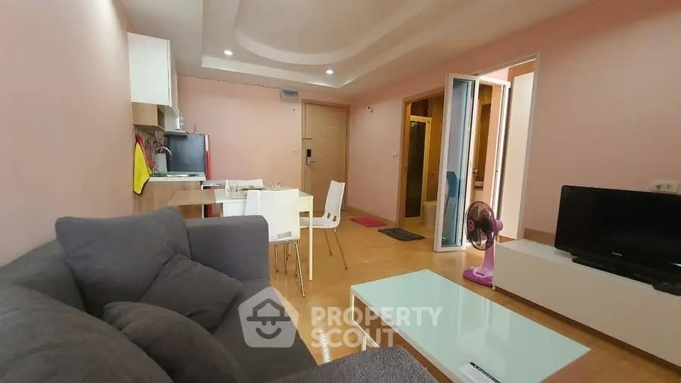 Modern living room with cozy sofa, dining area, and stylish decor in open layout apartment.