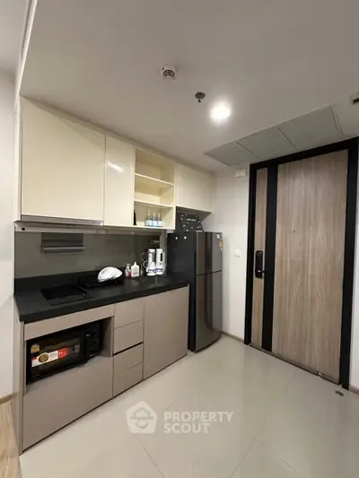 Modern kitchen with sleek cabinetry and appliances in a stylish apartment