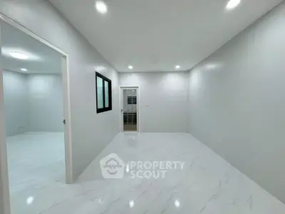 Spacious modern interior with sleek white flooring and ample lighting, perfect for customization.