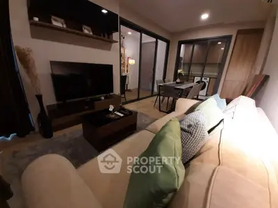 Stylish living room with modern decor and open kitchen layout, perfect for urban living.
