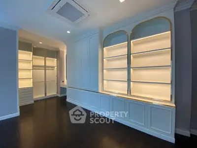 Elegant study room with built-in shelves and dark wood flooring