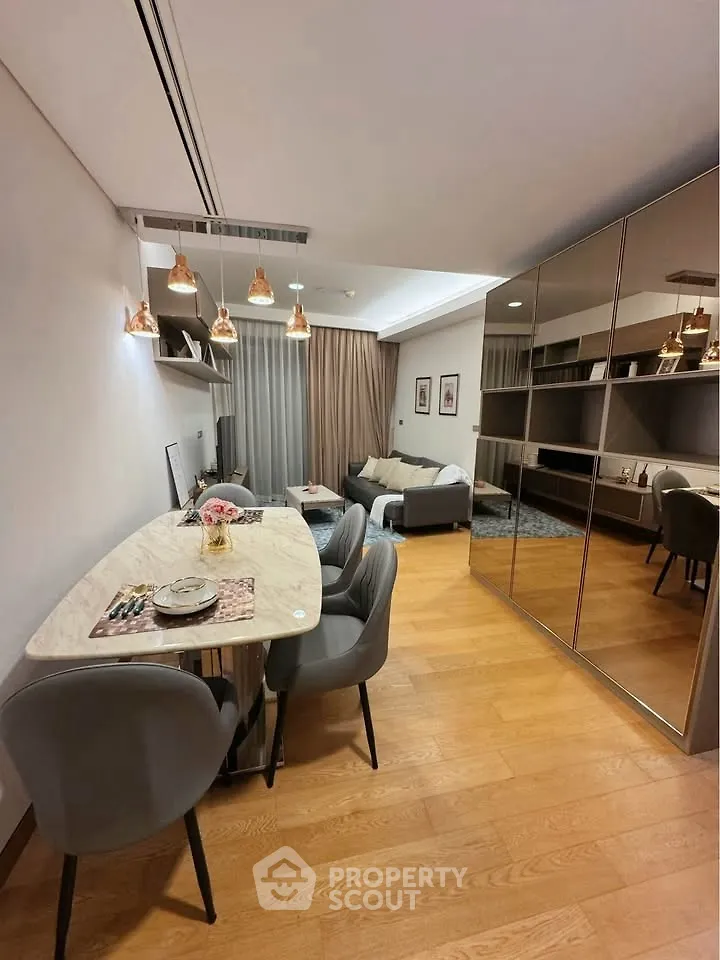 Modern living room with stylish dining area and mirrored wardrobe