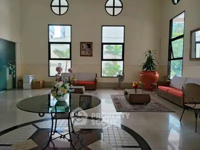 Elegant living room with high ceilings and stylish furniture, perfect for modern living.