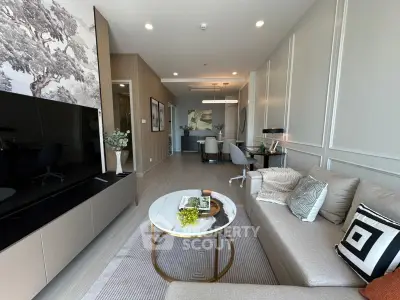 Modern living room with stylish decor and open layout, featuring a cozy sofa and elegant dining area.