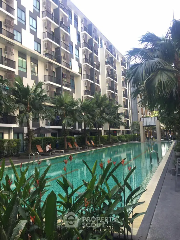 Luxurious condominium with stunning pool and lush greenery, perfect for relaxation and modern living.