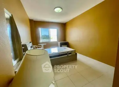 Spacious bedroom with natural light and modern furnishings