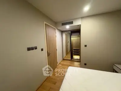 Modern bedroom with wooden flooring and built-in wardrobe