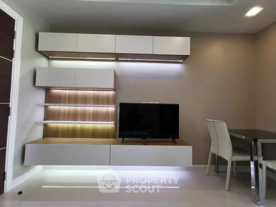 Modern living room with sleek wall-mounted TV unit and dining area