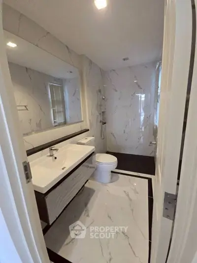 Luxurious modern bathroom with marble tiles and sleek fixtures