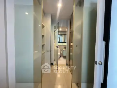Modern bathroom with sleek glass doors and elegant fixtures in a contemporary apartment.
