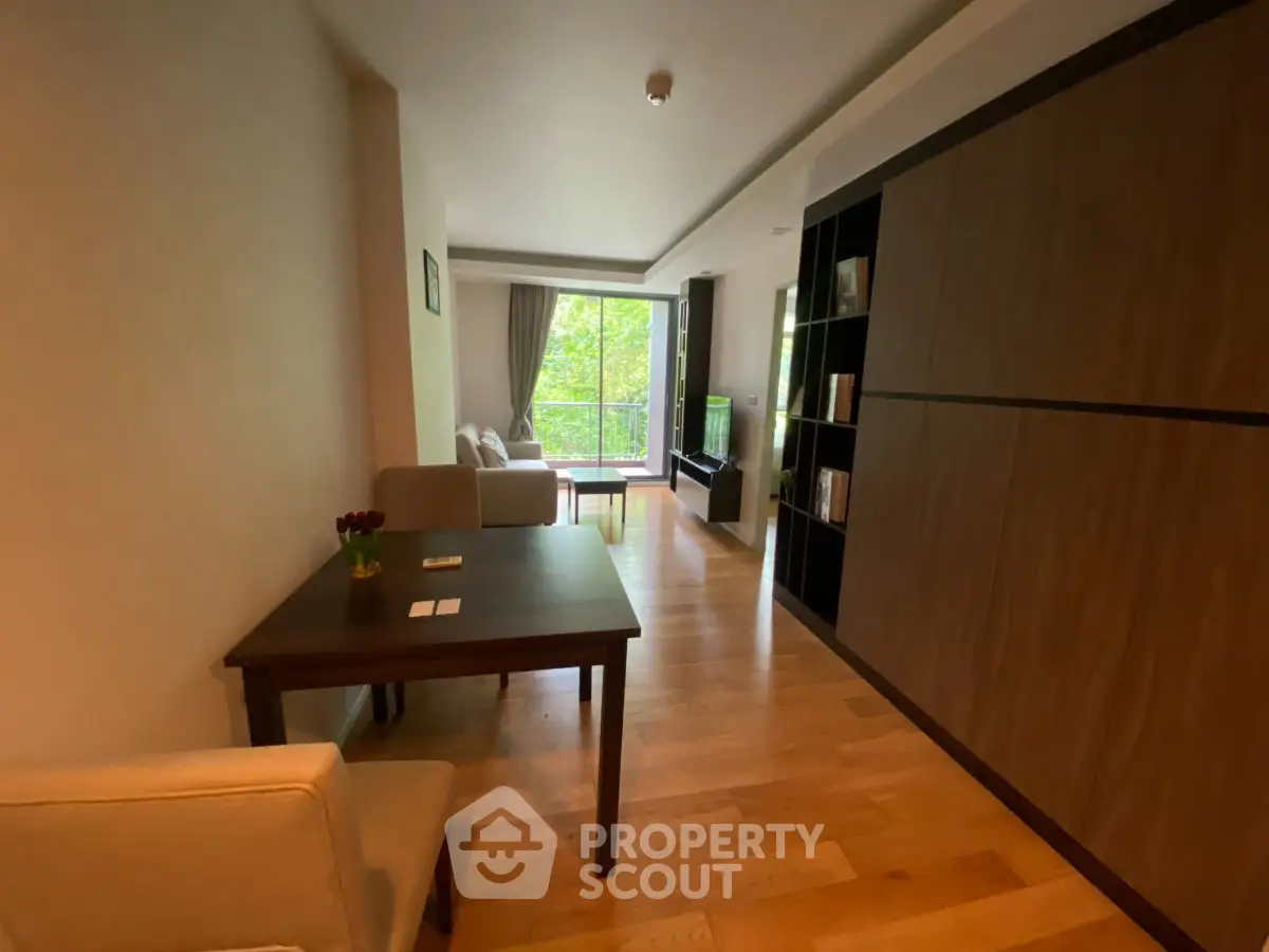 Spacious living room with wooden flooring and large window view